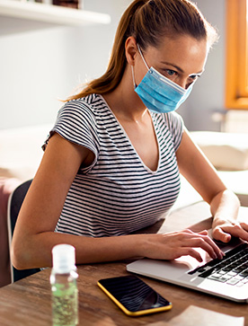 Woman in face mask is serching a recommendations about coronavirus Woman in face mask is serching a recommendations about coronavirus